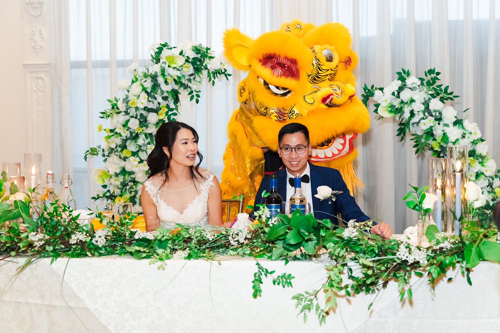 Monica and Andrew at their head table during a lion dance performance